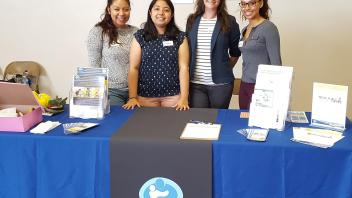 Elia, Lili, Amanda, and Lorena tabling at the Community Baby Shower