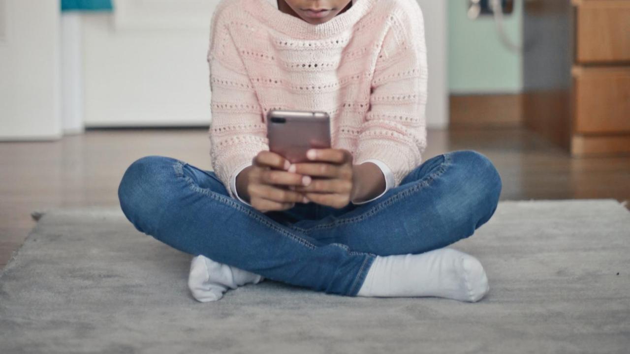 small girl on phone